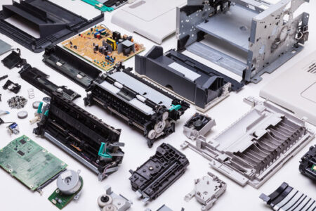 Printer components and spare parts laid out for preventive maintenance inspection and replacement