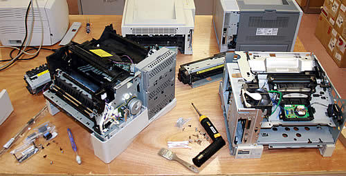 PrintFix Technologies workshop with printers undergoing repair and refurbishment by certified technicians